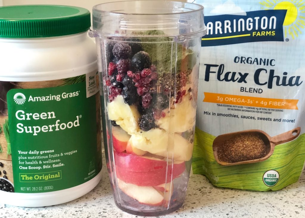 fruit in a smoothie with flax seed packaging and super greens jar