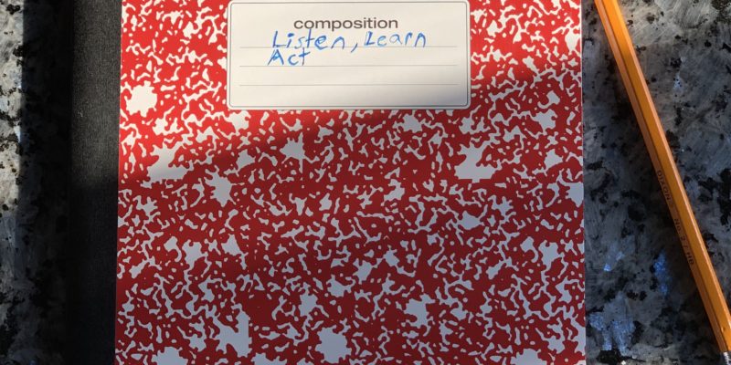 composition book and pencil with the words "listen learn act" written across the front