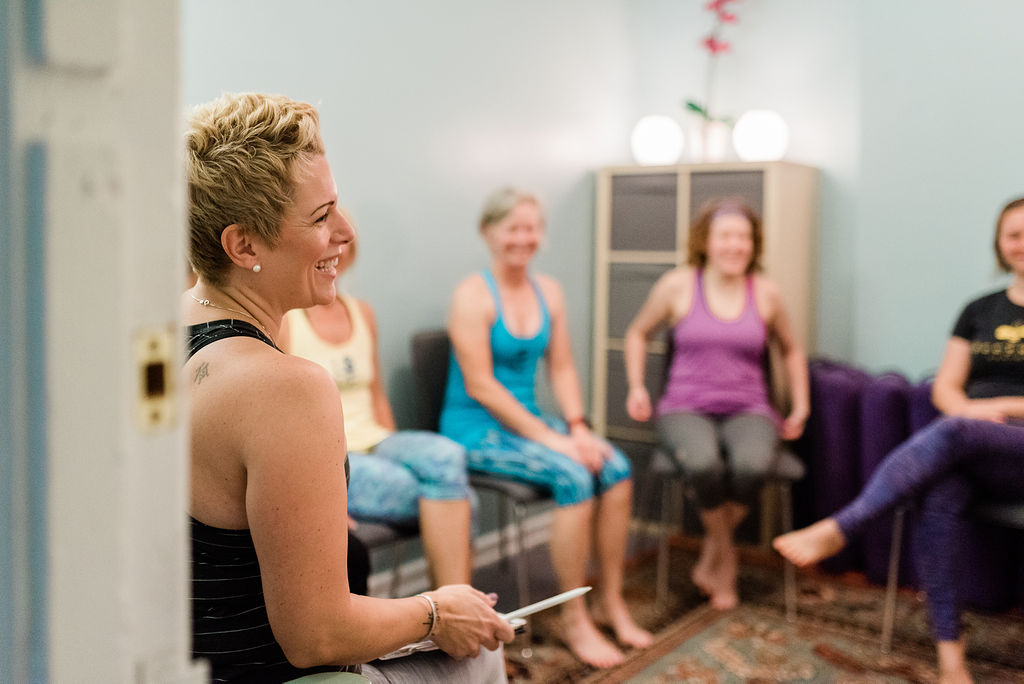 Gretchen sitting with a group of clients during a meeting