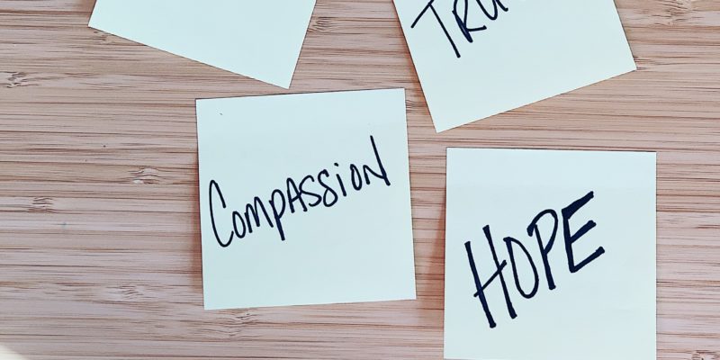 Empathy, compassion, truth , hope written on individual post-it notes