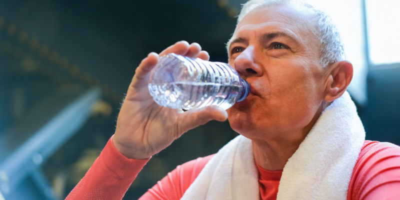 retired man drinking water